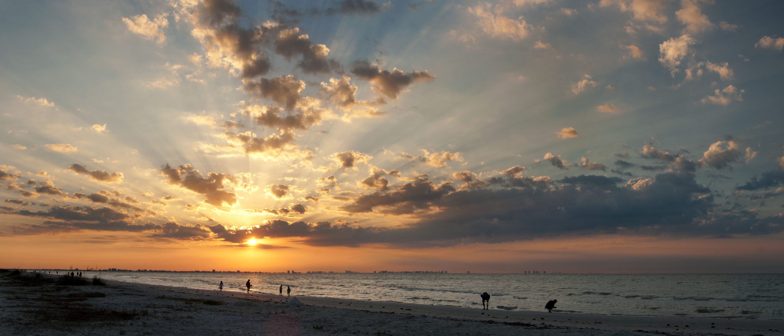 Rays of the sun pierce through clouds and a dark sky, like how hope enters hard circumstances