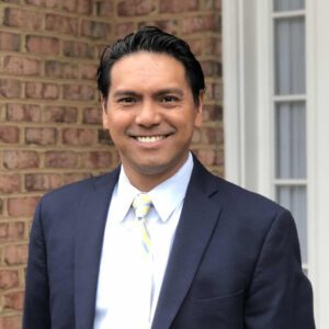 Edward Logan, attorney and cofounder of Filipino American Cancer Care, smiles in a business suit. 