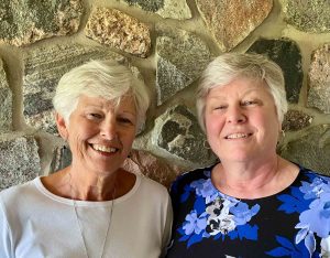 acute myeloid leukemia survivor Wilma DeRidder and her sister smile with a stone background