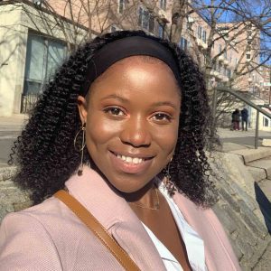 Wadzanayi Mayiseni, bone cancer survivor from Zimbabwe, smiles on a city street